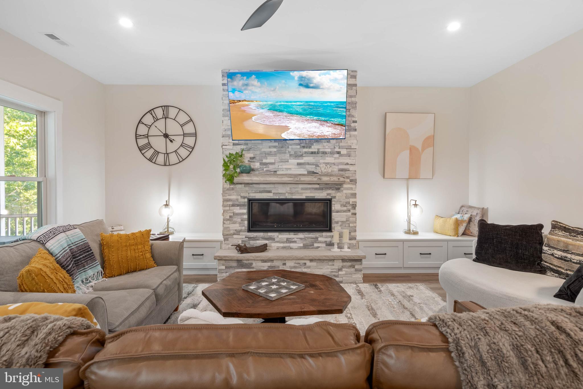 38155 Muddy Neck Road Ocean View, DE 19970 - Photo 19 of 67 a living room with furniture a fireplace and a large window