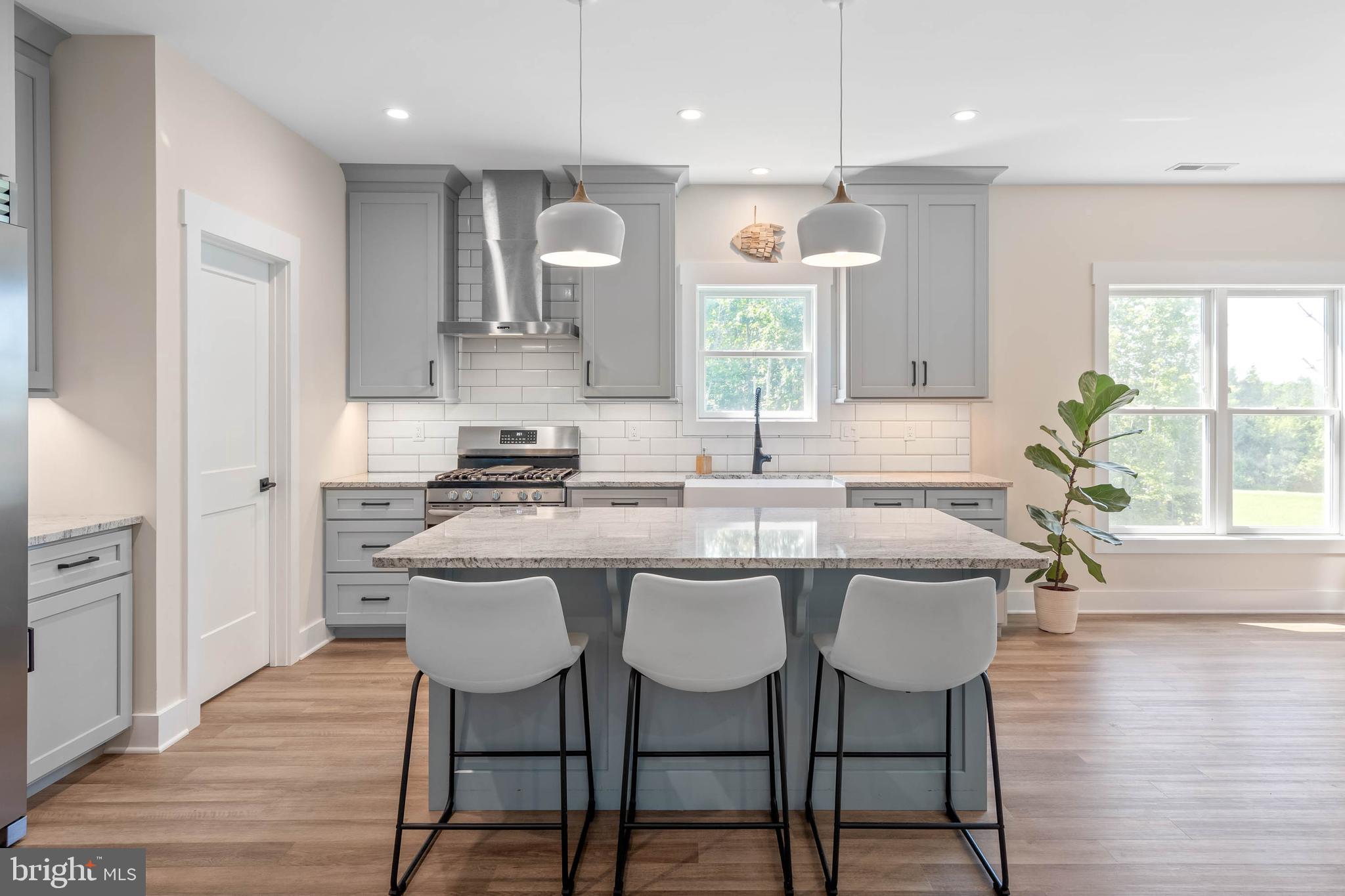 38155 Muddy Neck Road Ocean View, DE 19970 - Photo 22 of 67 a kitchen with granite countertop white cabinets and stainless steel appliances