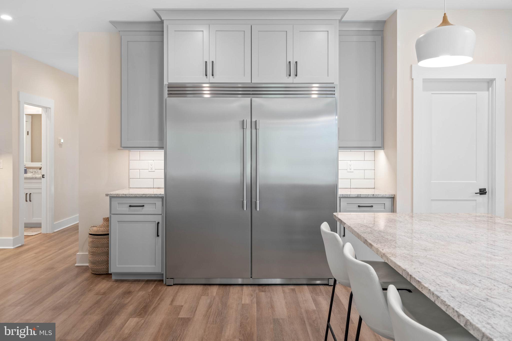 38155 Muddy Neck Road Ocean View, DE 19970 - Photo 24 of 67 a kitchen with white cabinets and refrigerator