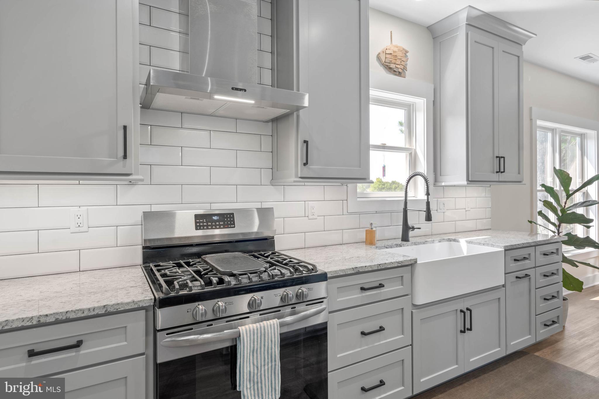 38155 Muddy Neck Road Ocean View, DE 19970 - Photo 28 of 67 a kitchen with white cabinets and appliances