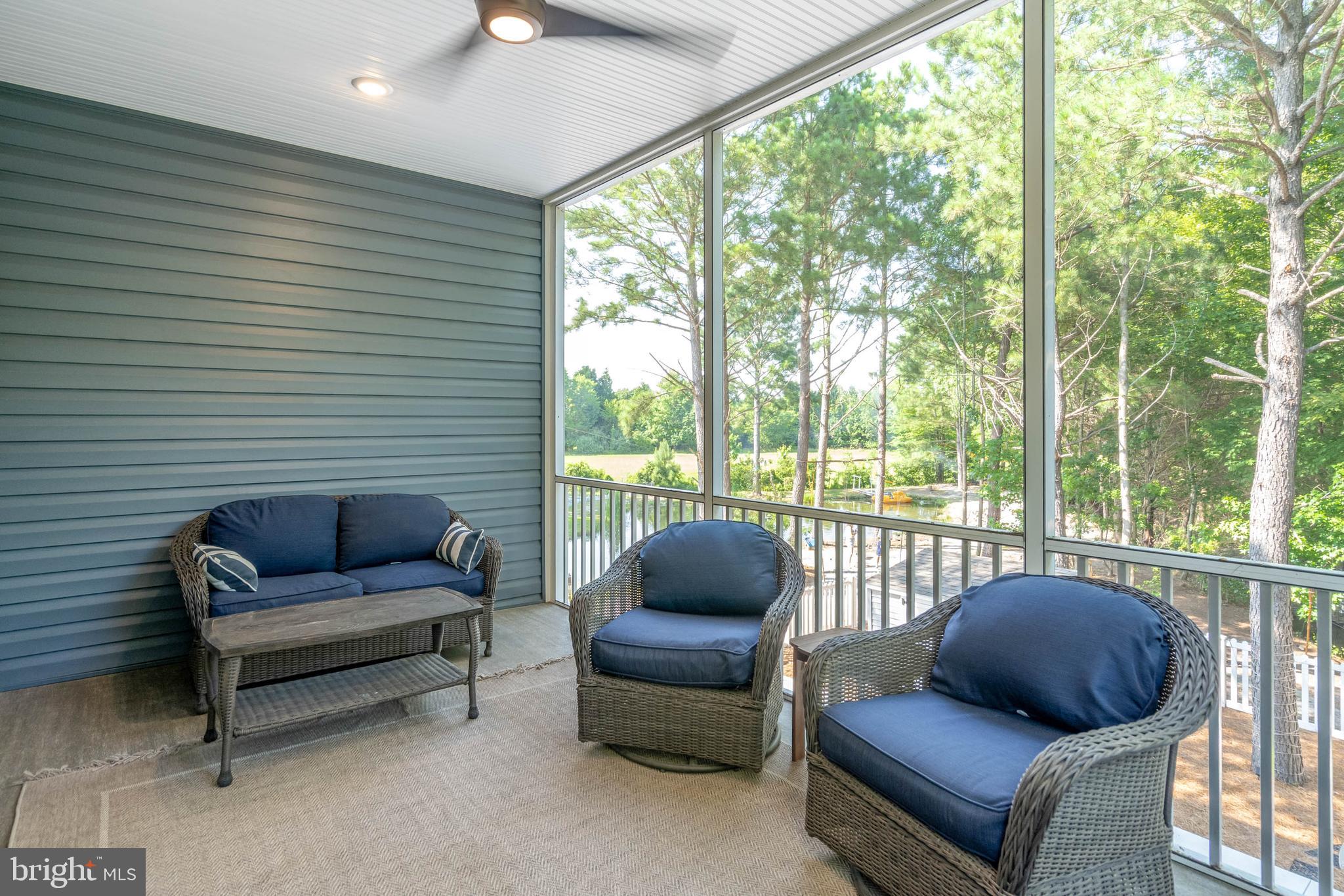 38155 Muddy Neck Road Ocean View, DE 19970 - Photo 42 of 67 a living room with furniture and a floor to ceiling window