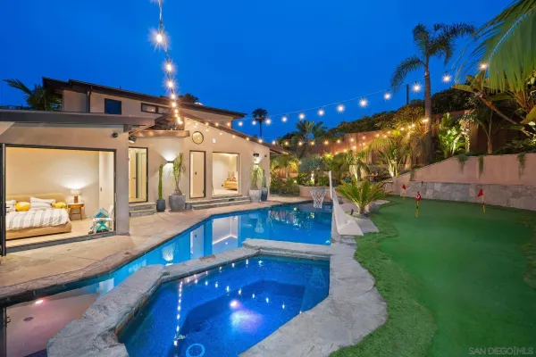 a bedroom with a bed and a mirror