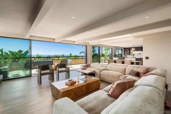 a room with stainless steel appliances kitchen island granite countertop a sink a stove and a wooden floors