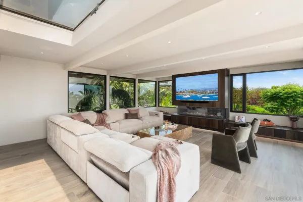 a open kitchen with stainless steel appliances kitchen island granite countertop a refrigerator a stove and a wooden floors