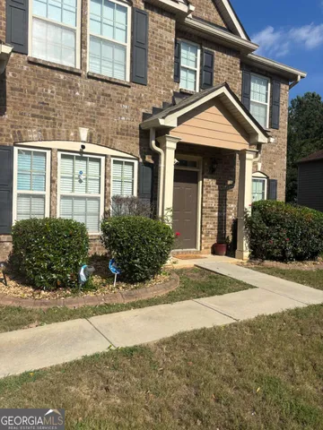 a front view of a house with a yard
