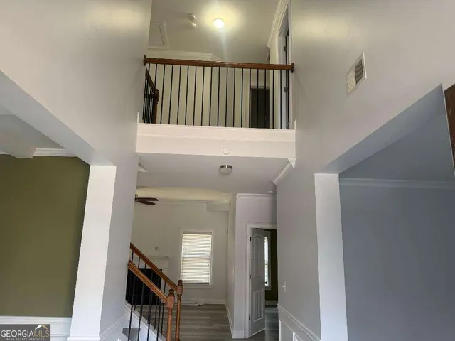 a view of staircase with white walls and a window