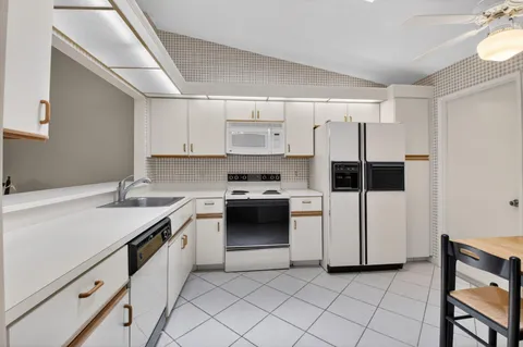 a kitchen with a sink stove and cabinets