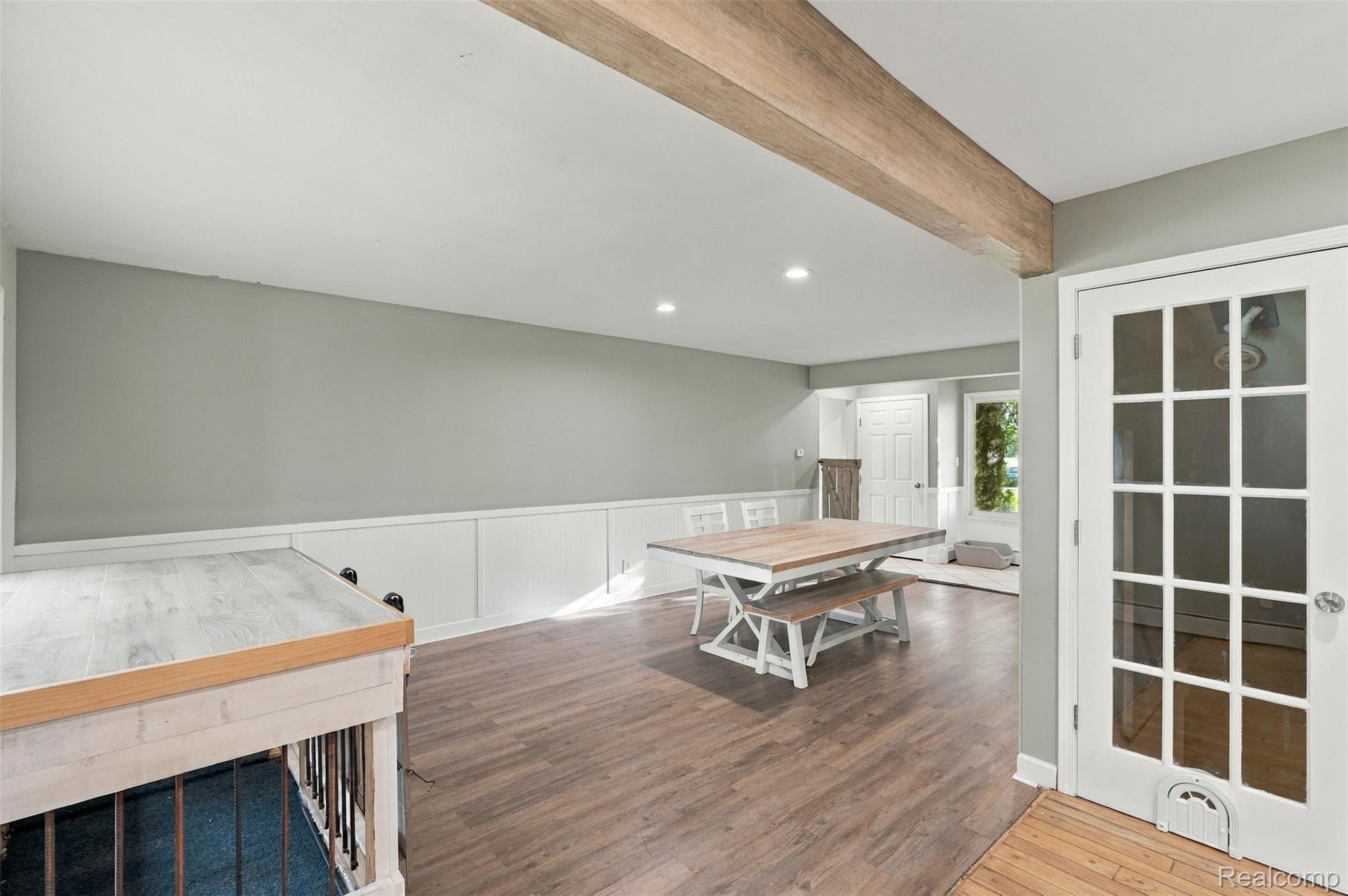 26516 Romine Road New Boston, MI 48164 - Photo 16 of 62 Wood-finish flooring, wainscoting, recessed lighting, exposed wood beam, and French pane door