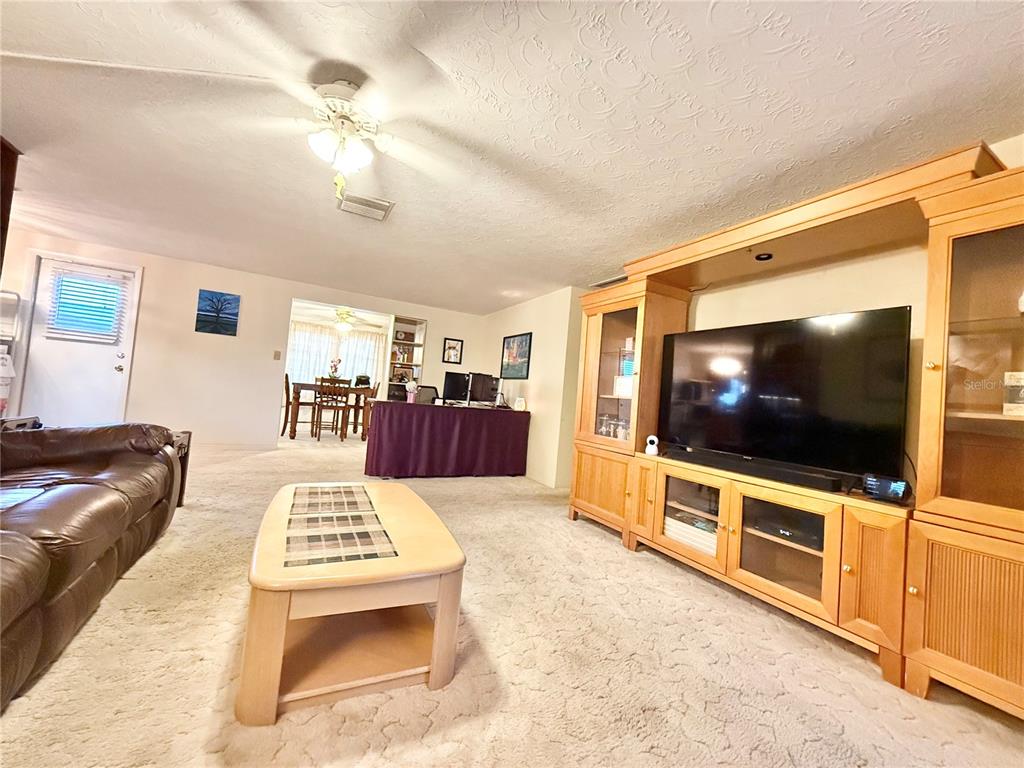 4935 Guardian Avenue Holiday, FL 34690 - Photo 14 of 32 a living room with furniture and a flat screen tv