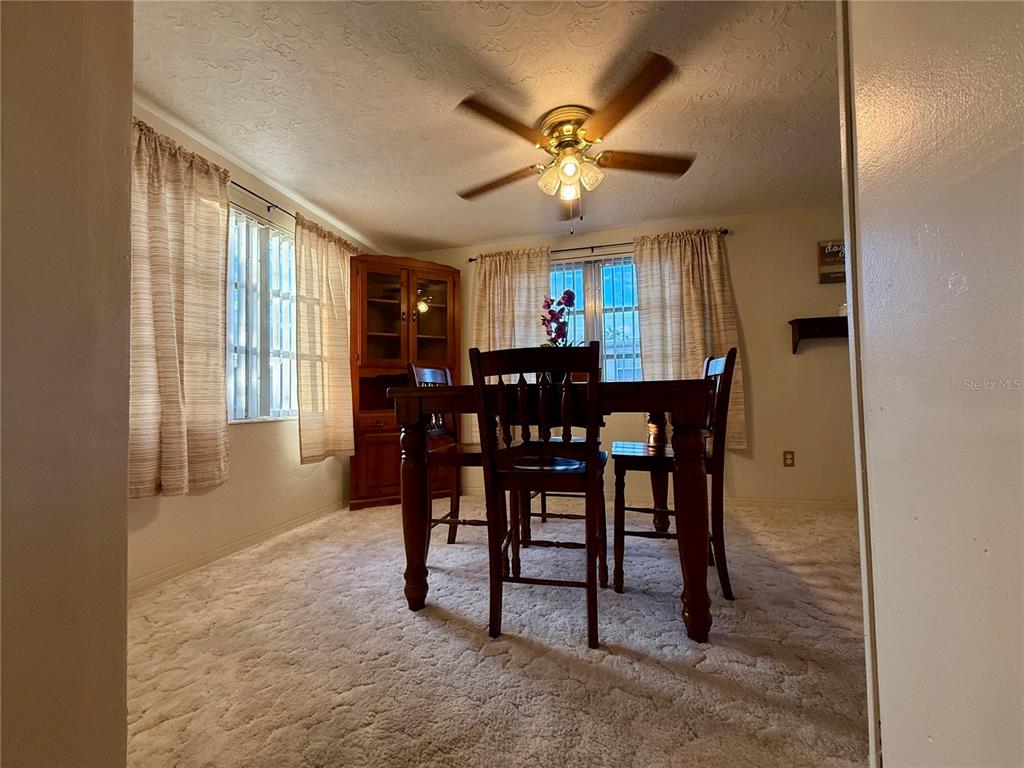 4935 Guardian Avenue Holiday, FL 34690 - Photo 19 of 32 a view of a dining room with furniture window and wooden floor