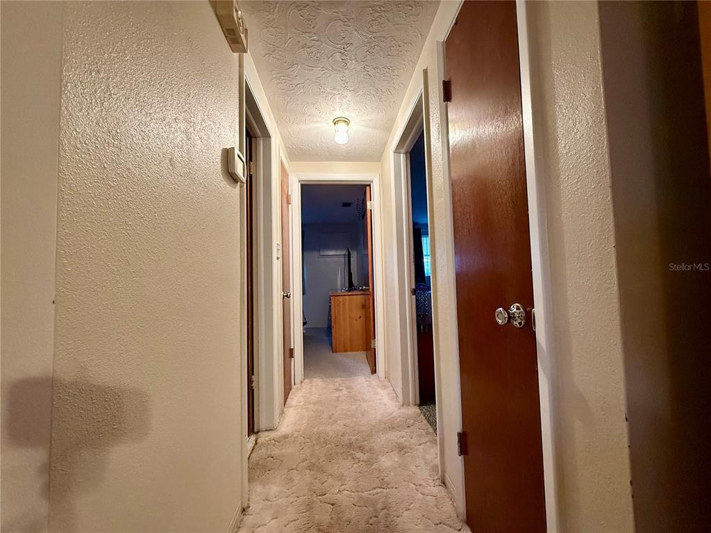 4935 Guardian Avenue Holiday, FL 34690 - Photo 21 of 32 a view of a hallway with wooden cabinets