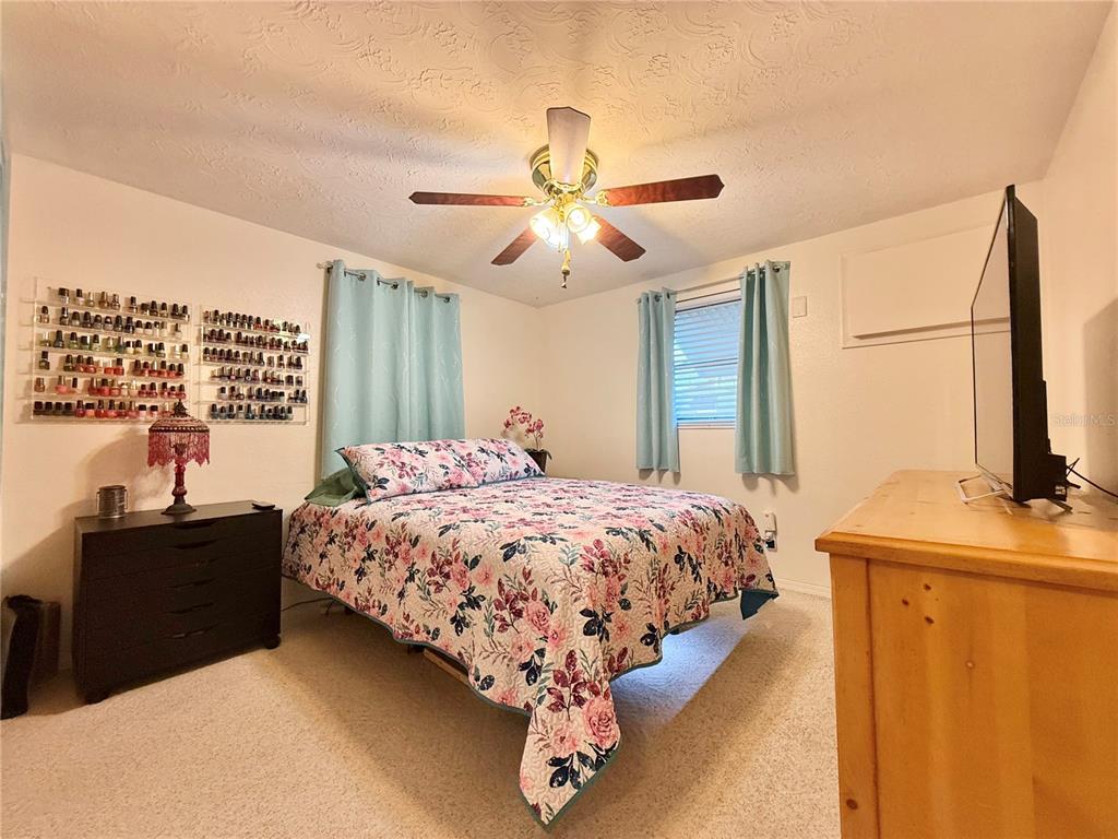 4935 Guardian Avenue Holiday, FL 34690 - Photo 24 of 32 a bed sitting in a bedroom next to a window