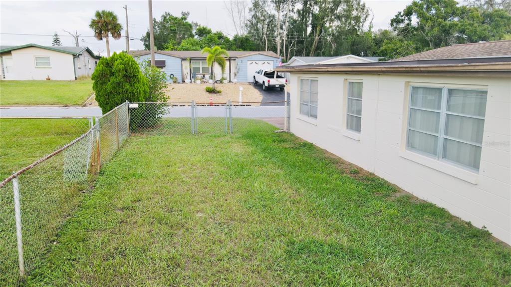 4935 Guardian Avenue Holiday, FL 34690 - Photo 7 of 32 a view of a house with backyard and a garden