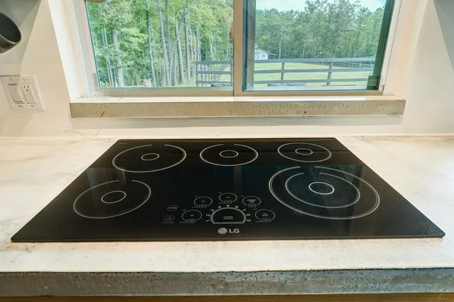 a bedroom with a bed and a flat tv screen on the dresser