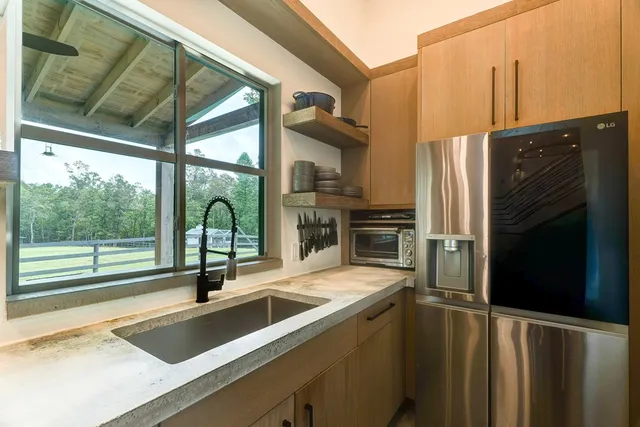 a living room with a rug and a wooden floor