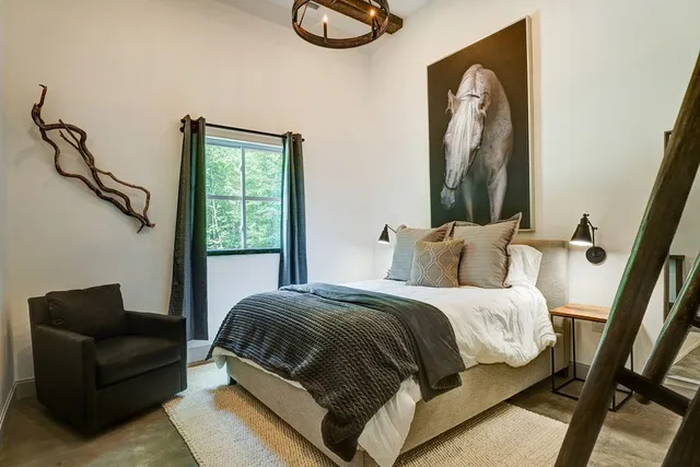 a bedroom with a bed and a night stand