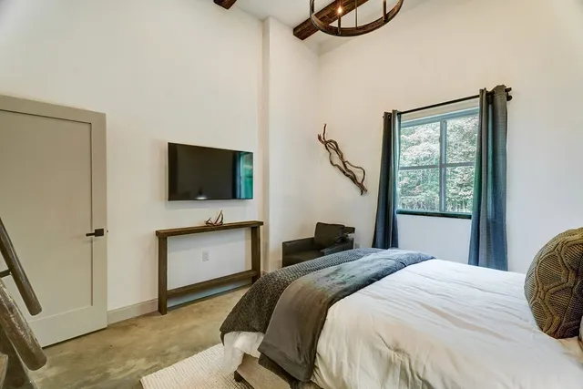 a bathroom with a granite countertop toilet sink and mirror