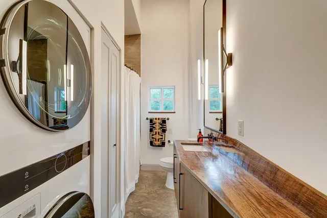 a spacious bedroom with a bed and a flat screen tv