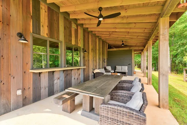a view of a swimming pool with a patio and a yard