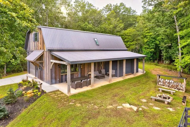 a front view of a house with swimming pool having outdoor seating