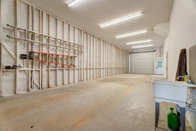 a view of a hallway with white walls and entryway