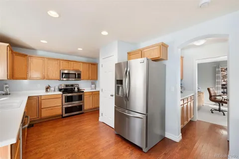 a kitchen with stainless steel appliances a refrigerator and a stove top oven