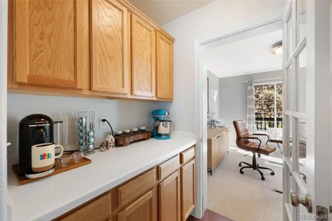 a view of a kitchen with sink cabinets and furniture