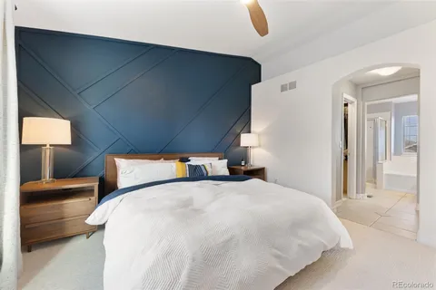 a bedroom with a bed and a view of living room