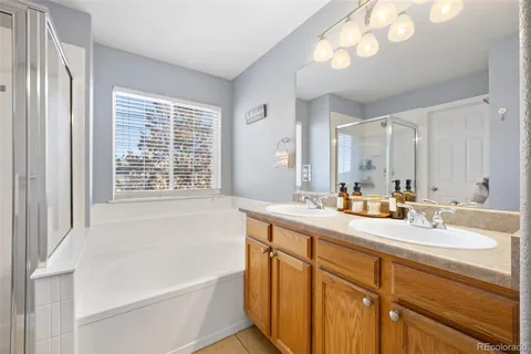 a bathroom with a tub sink and mirror