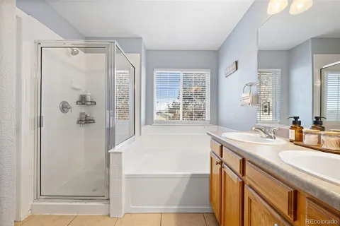 a bathroom with a granite countertop sink mirror and a bathtub