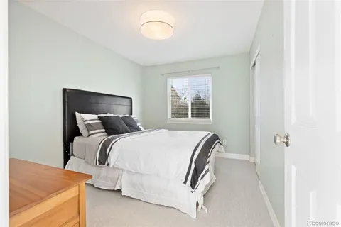 a bed room with a bed and a window