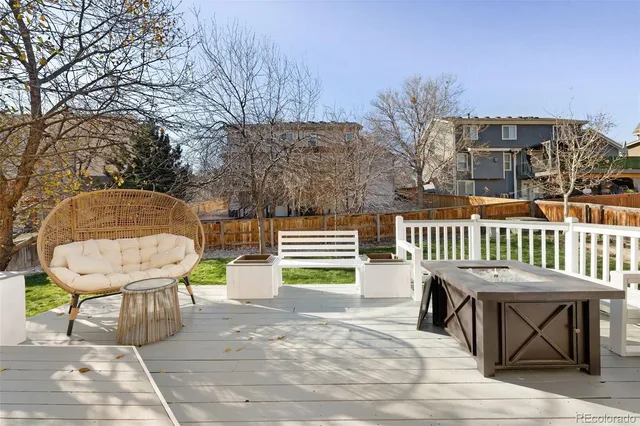 a view of a chairs and table in the backyard