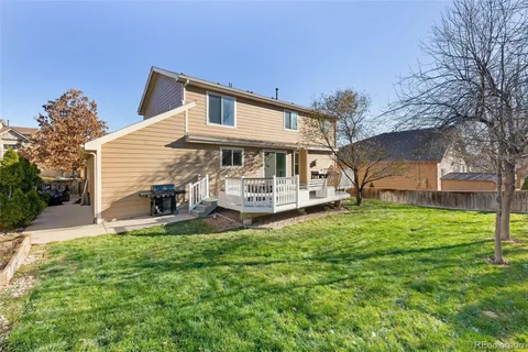 a view of a house with a yard porch and sitting area