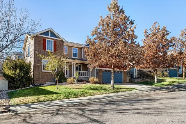a front view of a house with a yard and palm trees