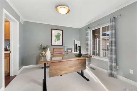 a room with a table chairs and a window