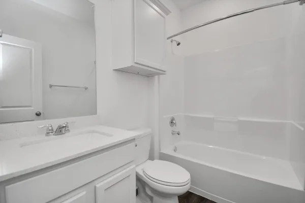 a bathroom with a sink toilet vanity and shower