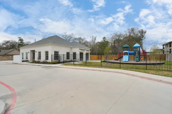 a view of a house with a big yard and large trees