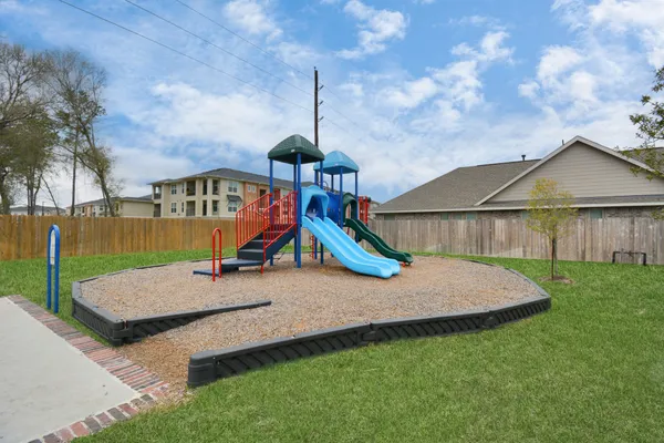 a view of outdoor space with playground and green space