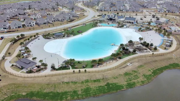 an aerial view of a house a yard and lake