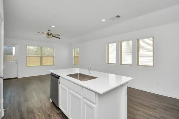 a kitchen that has a sink and a stove top oven