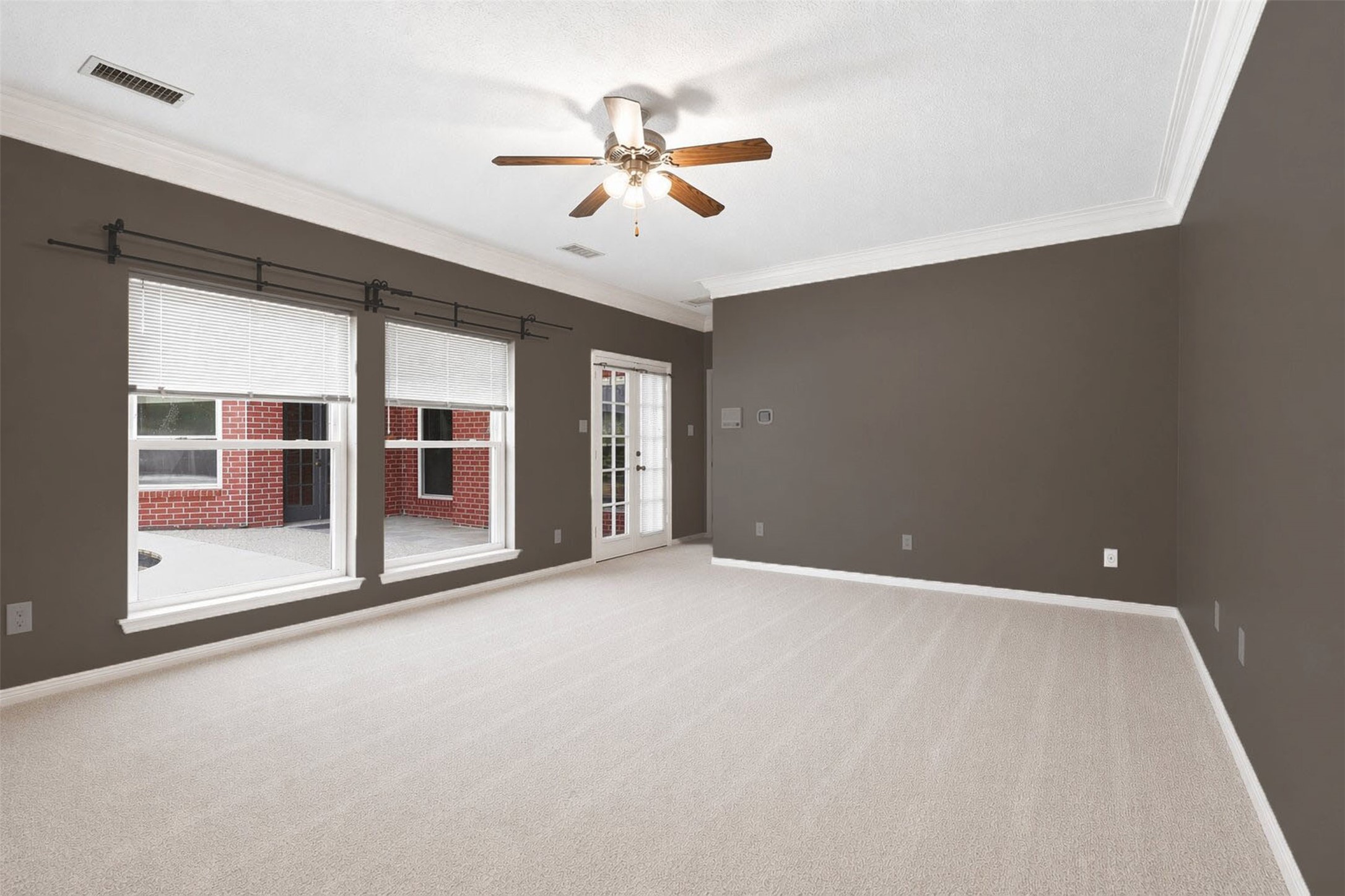 6118 Hampton Way Court Spring, TX 77389 - Photo 19 of 27 Primary bedroom with access to the back patio. Ceiling fan and plenty of light.