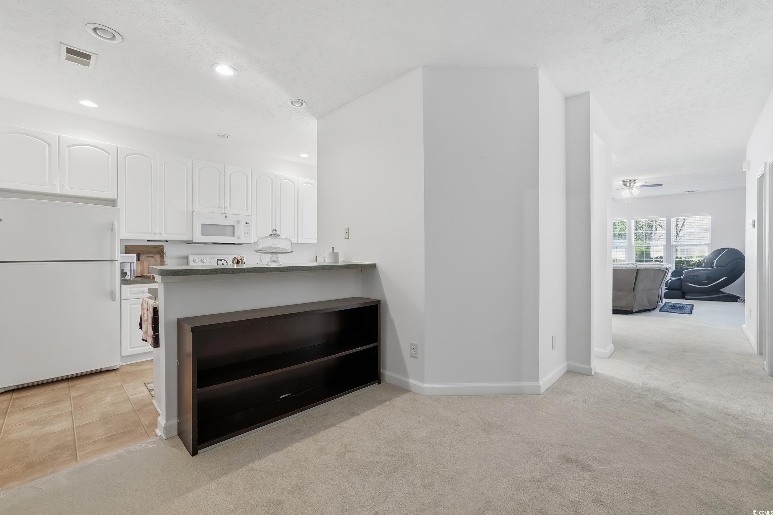 309 Meadowside Drive Little River, SC 29566 - Photo 13 of 40 Kitchen with white cabinetry, white appliances, light carpet, ceiling fan, and recessed lighting