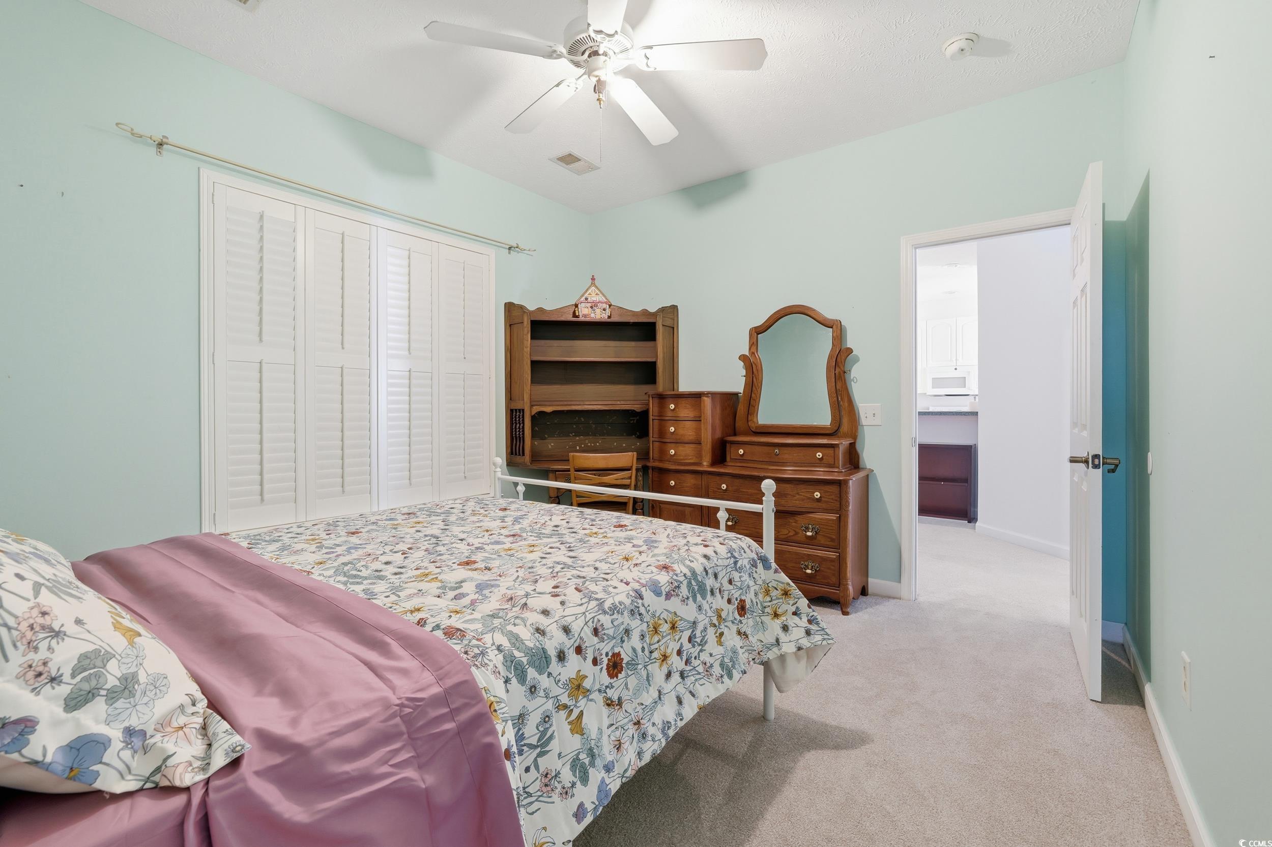 309 Meadowside Drive Little River, SC 29566 - Photo 16 of 40 Bedroom with light carpet and a ceiling fan