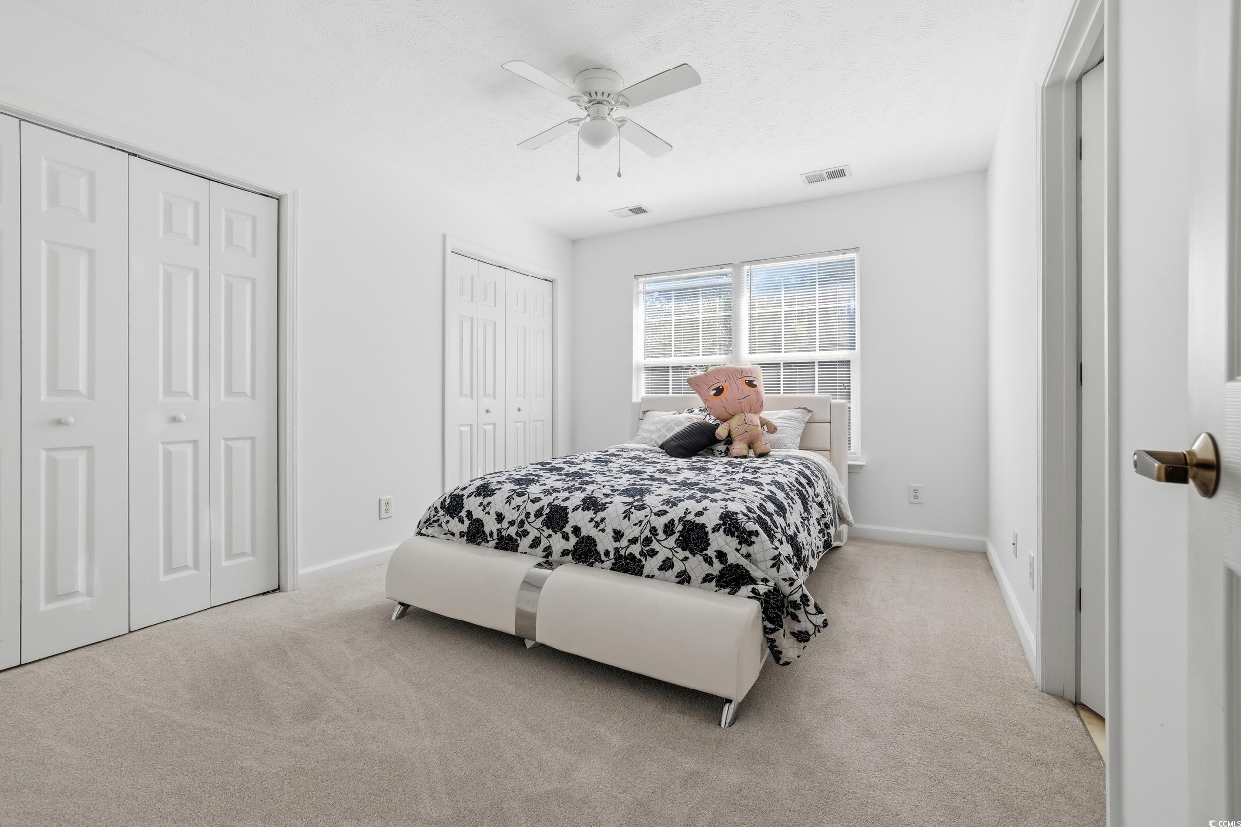 309 Meadowside Drive Little River, SC 29566 - Photo 22 of 40 Bedroom with multiple closets, carpet flooring, and a ceiling fan