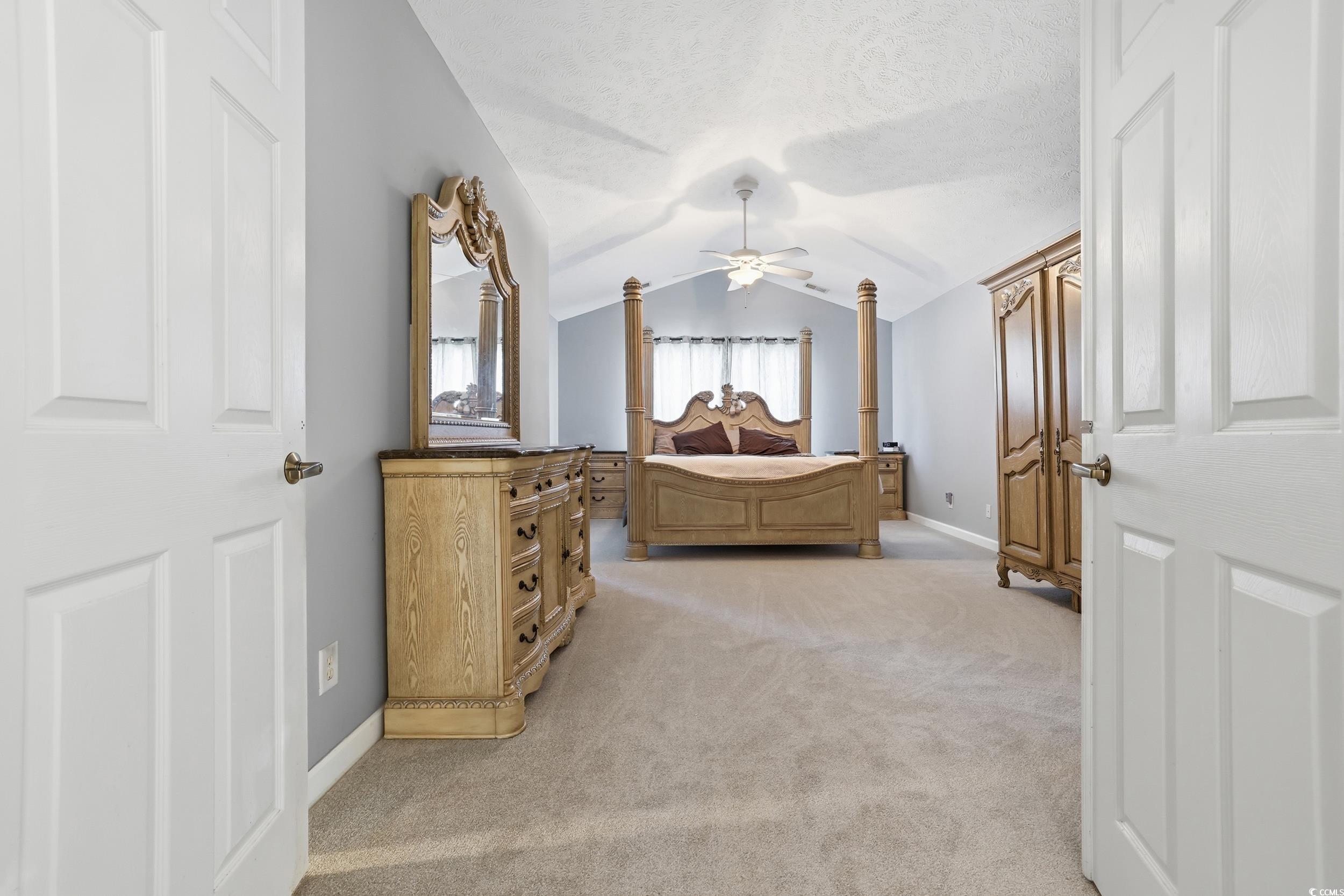 309 Meadowside Drive Little River, SC 29566 - Photo 28 of 40 Bedroom with light colored carpet, lofted ceiling, ceiling fan, and a textured ceiling
