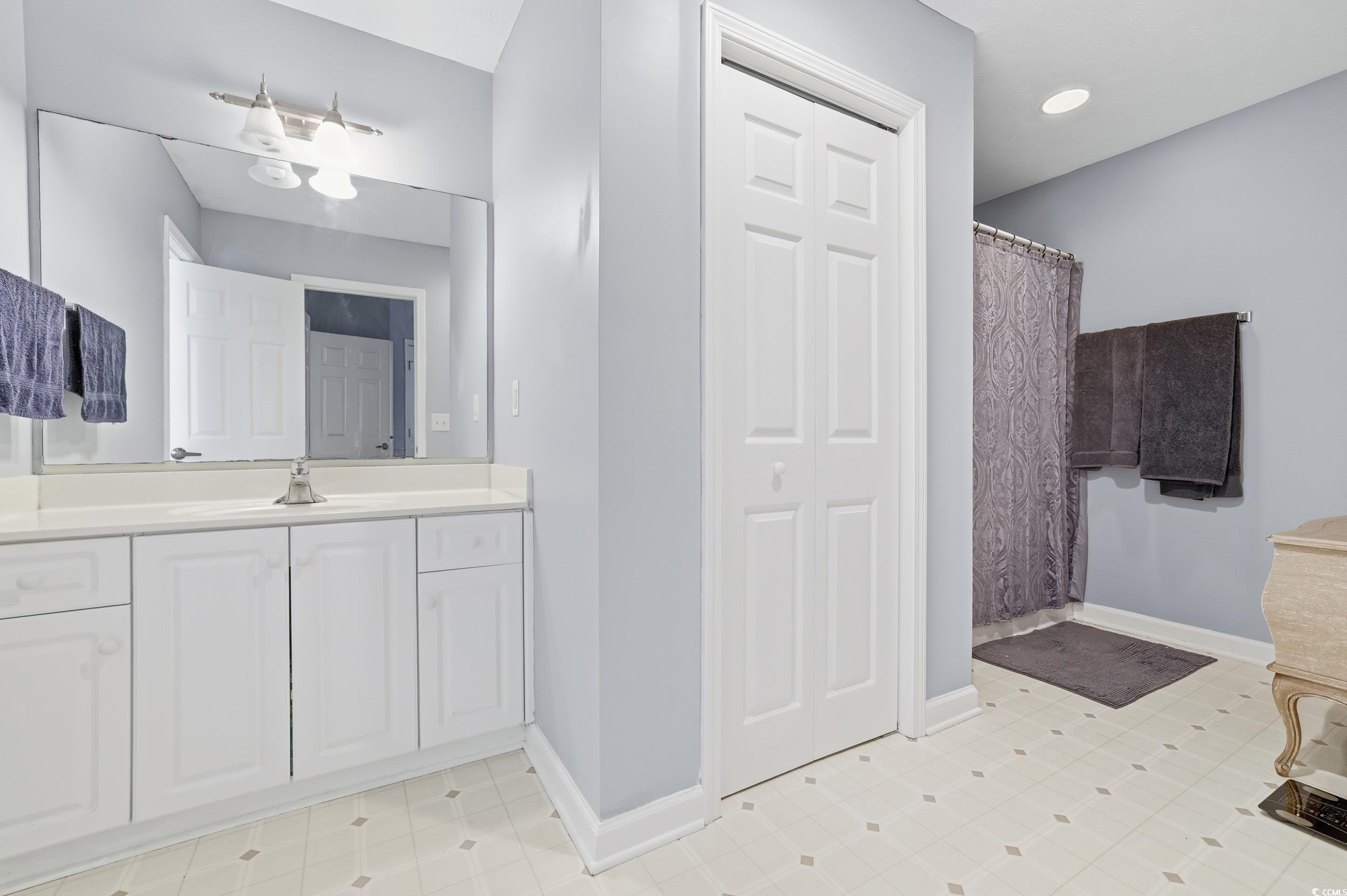 309 Meadowside Drive Little River, SC 29566 - Photo 30 of 40 Full bath featuring a closet, vanity, and a shower with curtain