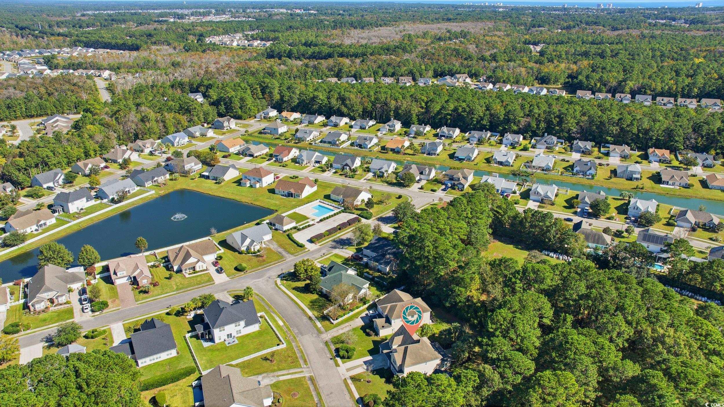 309 Meadowside Drive Little River, SC 29566 - Photo 39 of 40 Aerial view of property and surrounding area featuring a large body of water and nearby suburban area