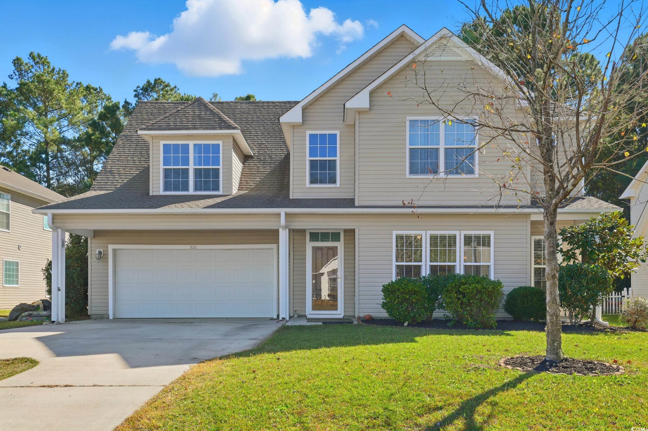 309 Meadowside Drive Little River, SC 29566 - Photo 5 of 40 Traditional-style house featuring concrete driveway, a shingled roof, a front yard, and a garage