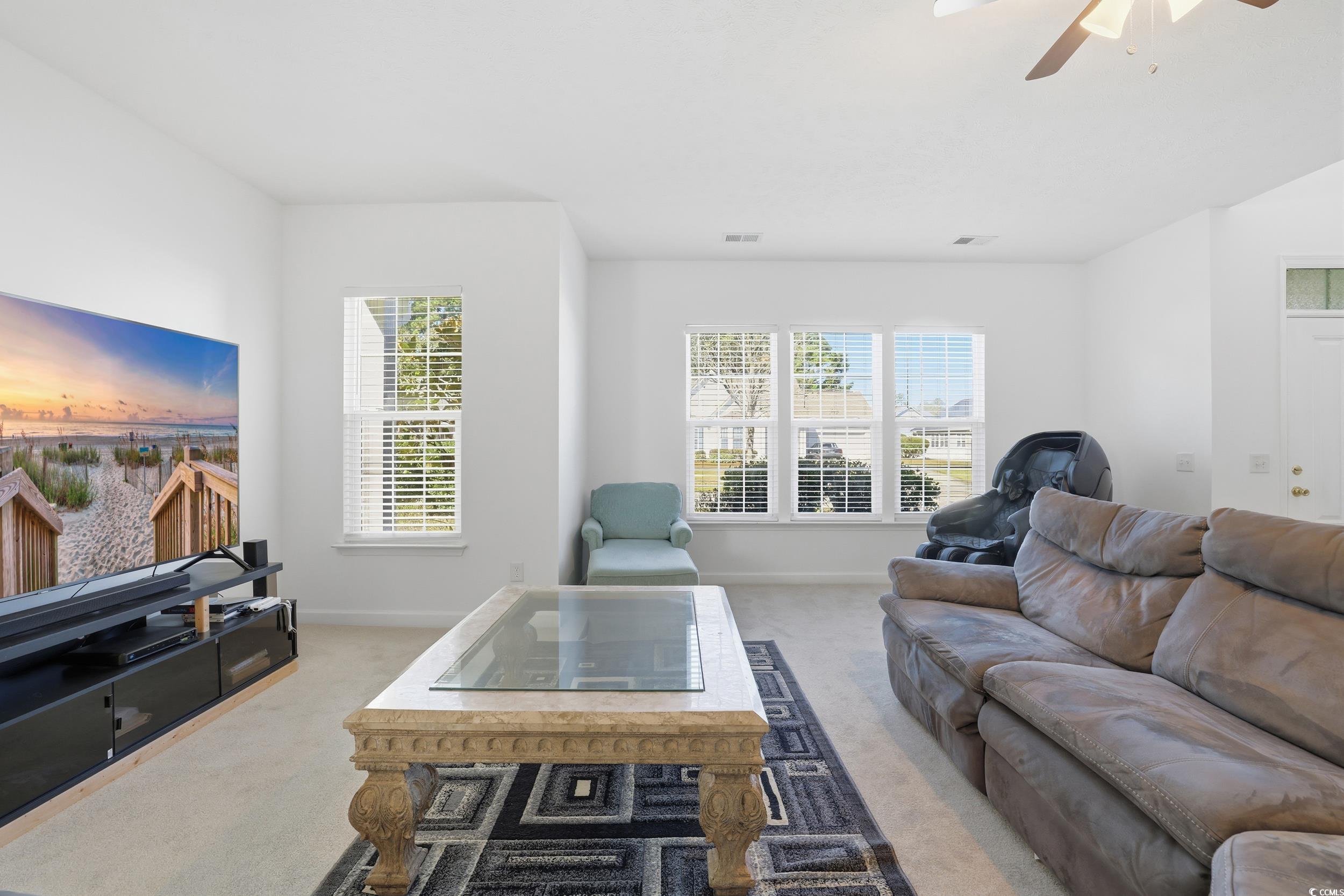 309 Meadowside Drive Little River, SC 29566 - Photo 8 of 40 Carpeted living room with ceiling fan and baseboards