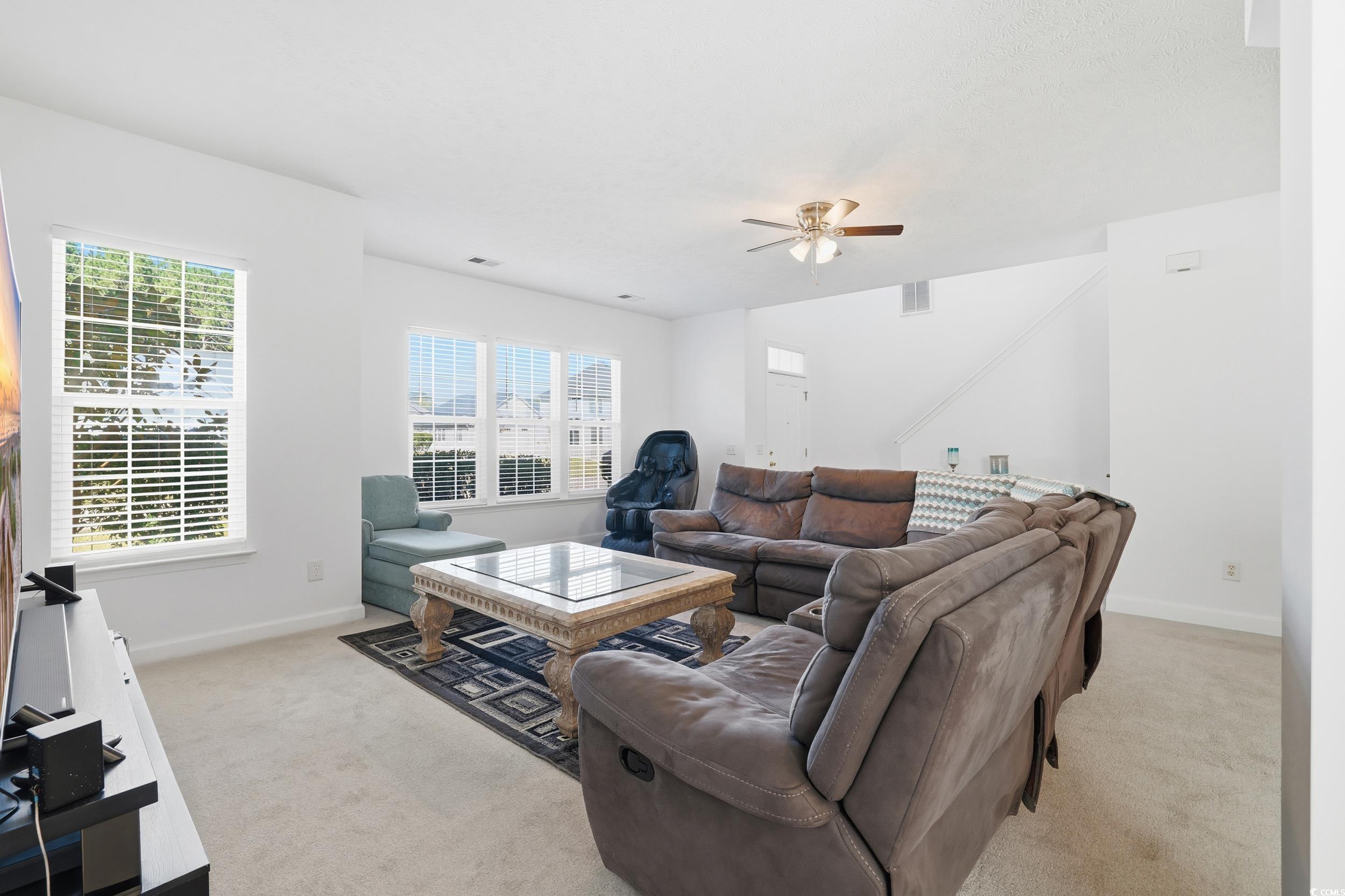 309 Meadowside Drive Little River, SC 29566 - Photo 9 of 40 Living room with light colored carpet and a ceiling fan